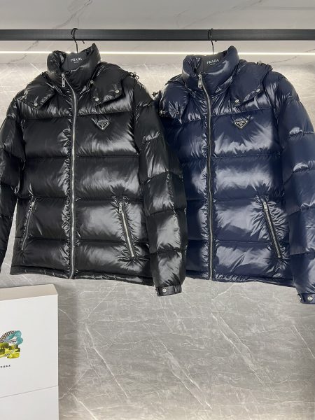 Top Prada Re-Nylon Thick Jacket with 90% down filling. Minimalist design, recycled material. Sizes 48-56, colors black and blue.