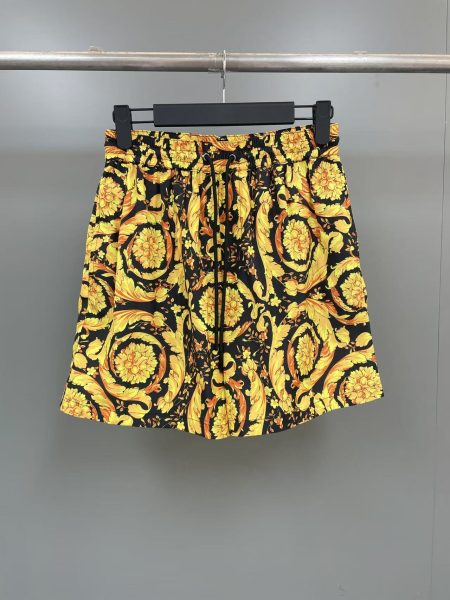 Versace men's mid-length Barocco swim trunks with iconic print, adjustable drawstring waist. 100% polyester, lining 75% nylon 25% spandex.